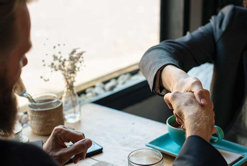Handshake between businessman and businesswoman