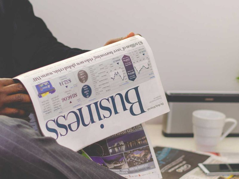 Man holding business newspaper