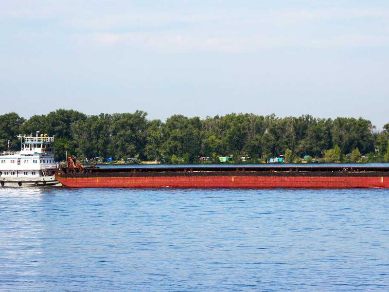 Tugboat pushing a barge on a river